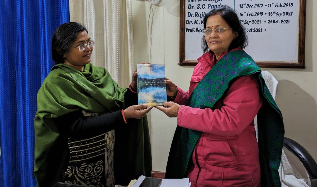 Musing by a Riverbank" by Dr Attrayee Adhya Chatterjee Presented to Dr. Veena Singh, Principal of G.D. Binani P.G. College Dr Veena Singh